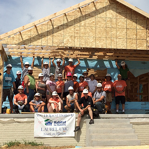 group of people in front of newly built home
